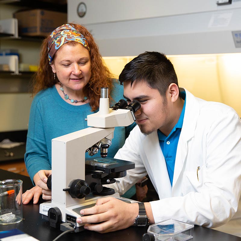 student at microscope