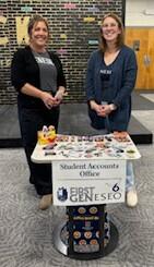 Two women standing at first Geneseo table