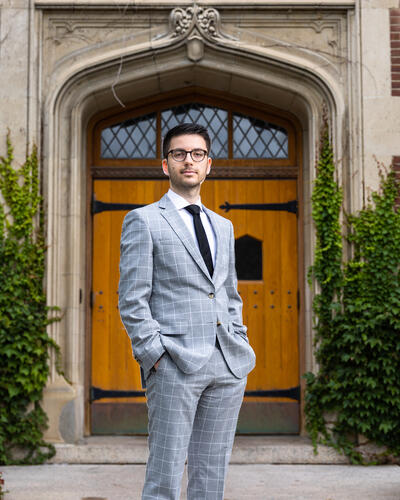 picture of Goga in shirt, tie and jacket, looking directly at camera