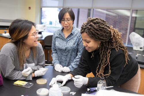 Suann Yang, associate professor of biology, with two biology students.