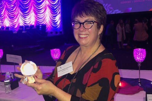 Denise Reed Lamoreaux with her ATHENA globe