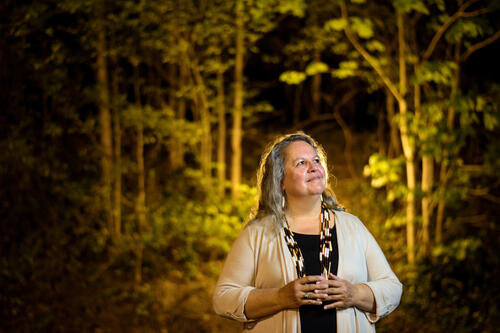 Portrait of Robin Wall Kimmerer in the woods 