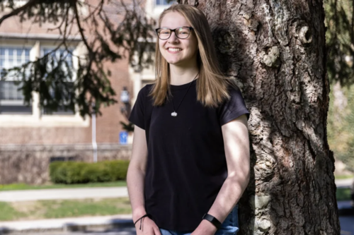 Kaitlin Anzalone '24 beside a tree in the College Circle