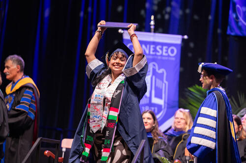 grad holding diploma