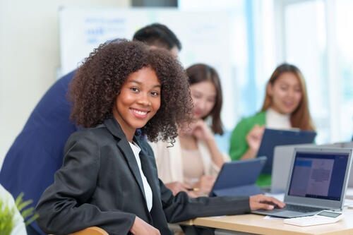 woman in suit with laptop in meeting