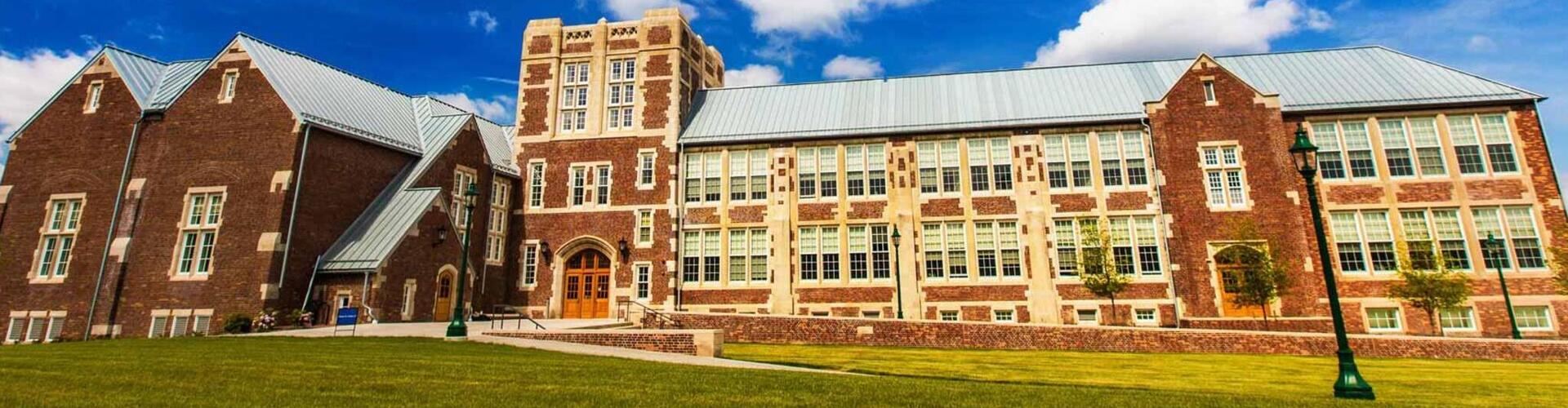 View of Doty Hall, a red brick building framed against a blue sky.