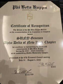 Elegant certificate reading "Certificate of Recognition / The Senate of the Phi Beta Kappa Society / on the recommendation of the Committee on Chapters / honors / SUNY Geneseo / Alpha Delta of New York Chapter / for excellence in representing the ideals and / commitments of Phi Beta Kappa / during the 2021 - 2024 triennium / as an outstanding Public University Chapter. / Presented at the 47th Triennial Council meeting / July 31 - August 4, 2024" and signed by the president and secretary of PBK