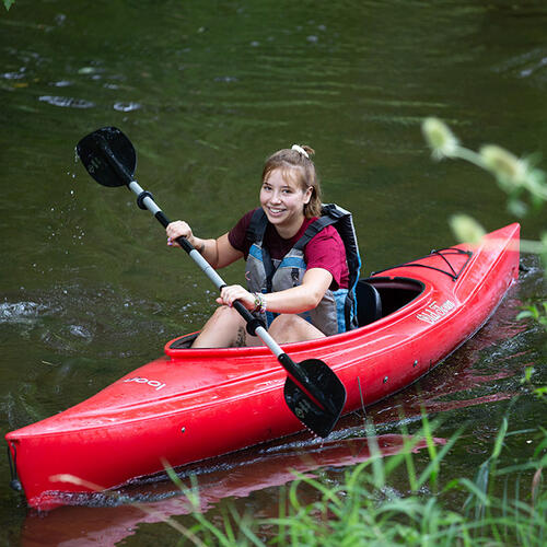 student kayaking