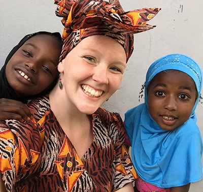 Jessica posing with two children.